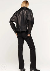 Women wearing a black leather biker jacket and pants on a white background