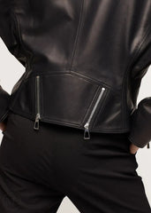 Close-up of a black leather Biker jacket with zippers on a neutral background