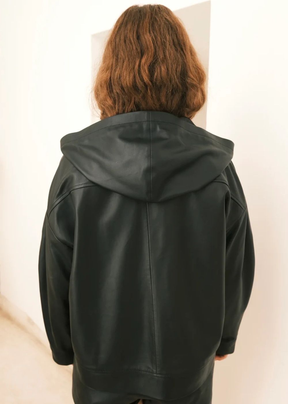 Women wearing a black Hoodie jacket against a white background
