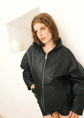 Women wearing a black Hoodie jacket against a white background