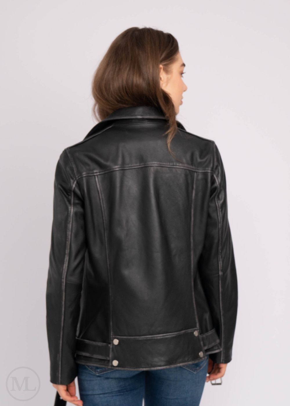 Women wearing a black leather jacket on a plain background