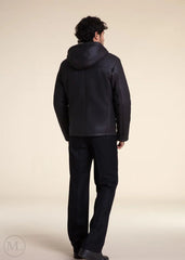Man wearing a  Dark Grey Hooded Shearling leather jacket and pants on a beige background