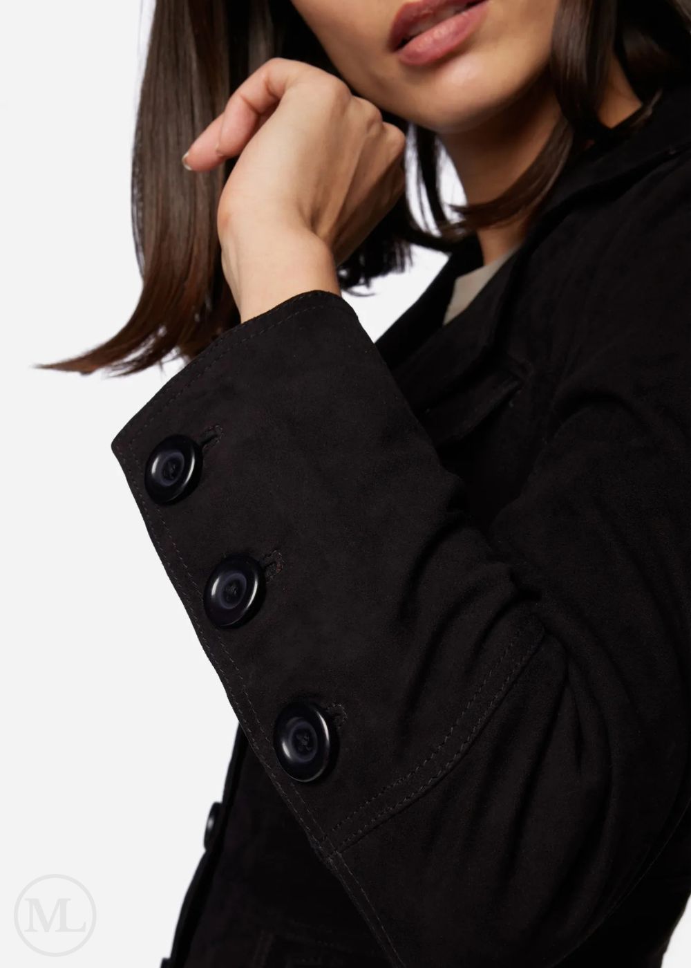 Close-up of a person wearing a black coat with buttons on a white background
