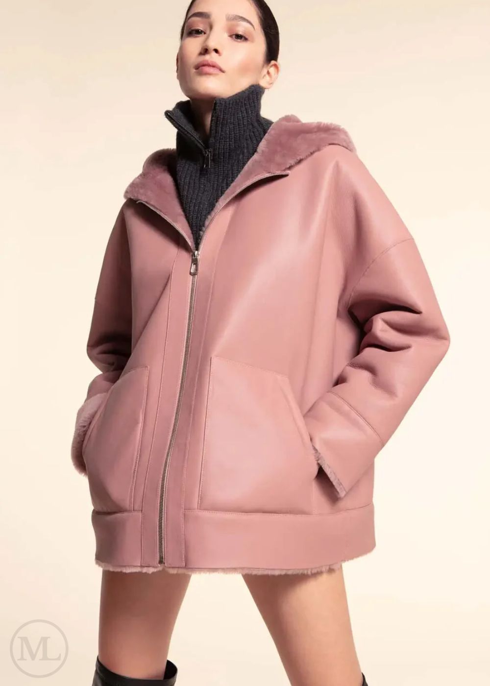Fuschia leather hooded jacket worn by a model on a beige background