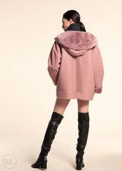 women wearing a fuschia leather hooded jacket  with a hood on a beige background