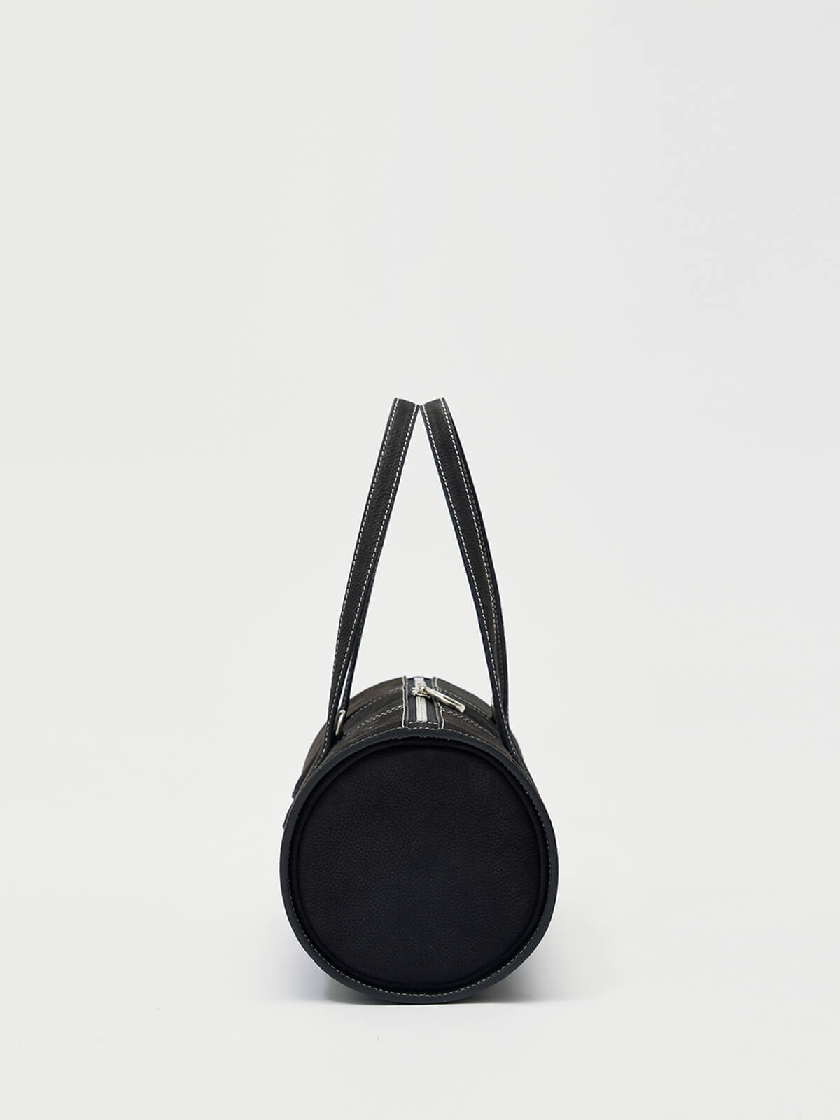Black cylindrical handbag with a strap on a white background